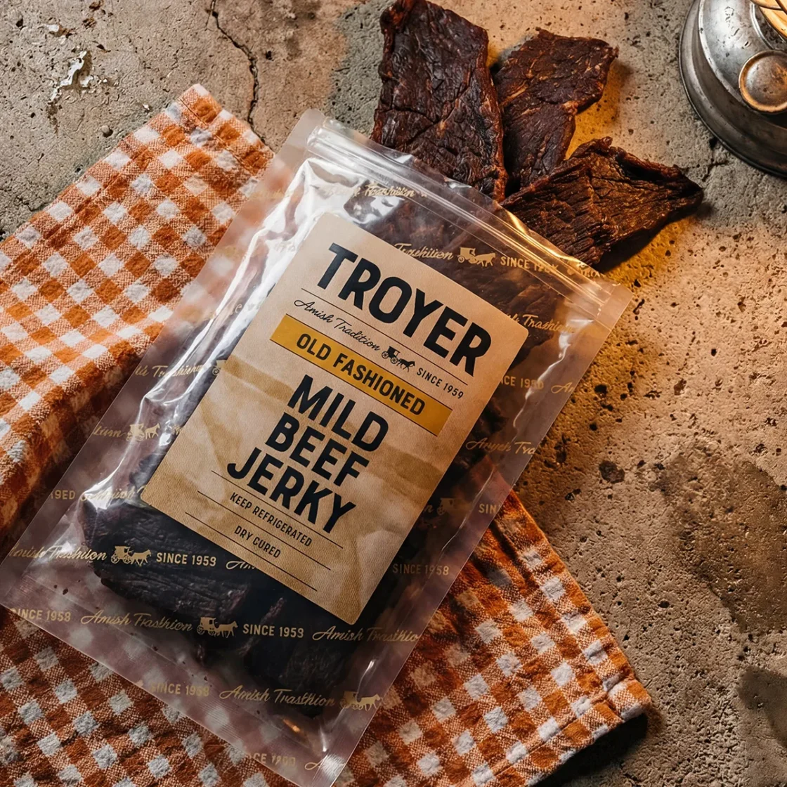 Troyer brand Old Fashioned Mild Beef Jerky package displayed with dried beef strips, showcasing premium wholesale jerkys.